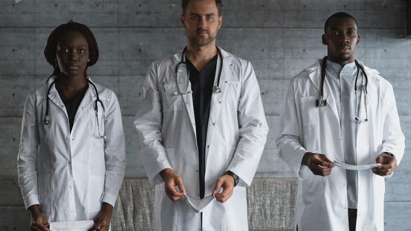 Team of clinicians in white coats