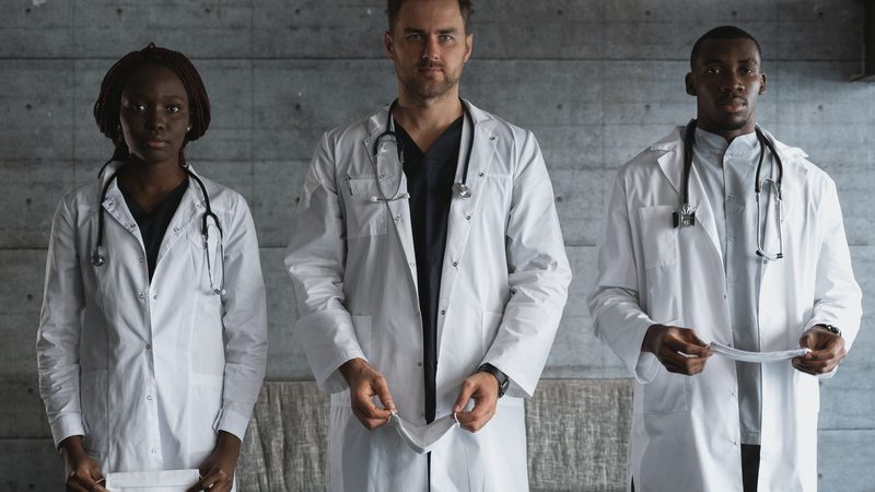Team of clinicians in white coats